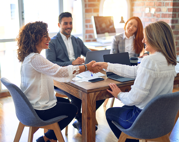 Image of people shaking hands during a meeting 