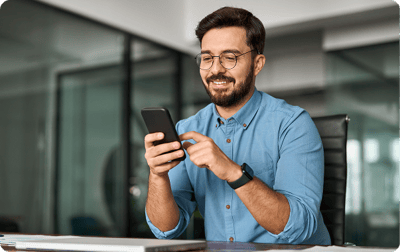image of man smiling at his phone image of man smiling at his phone