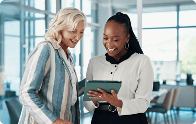 image of two women happily viewing an iPad image of two women happily viewing an iPad